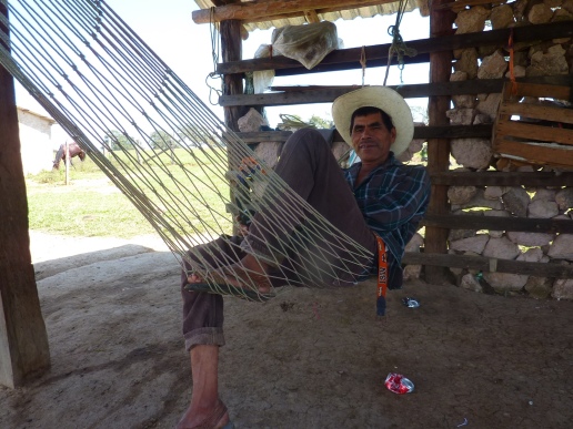 Pete visits with a Nahuatl man while he relaxes in his hammock. 